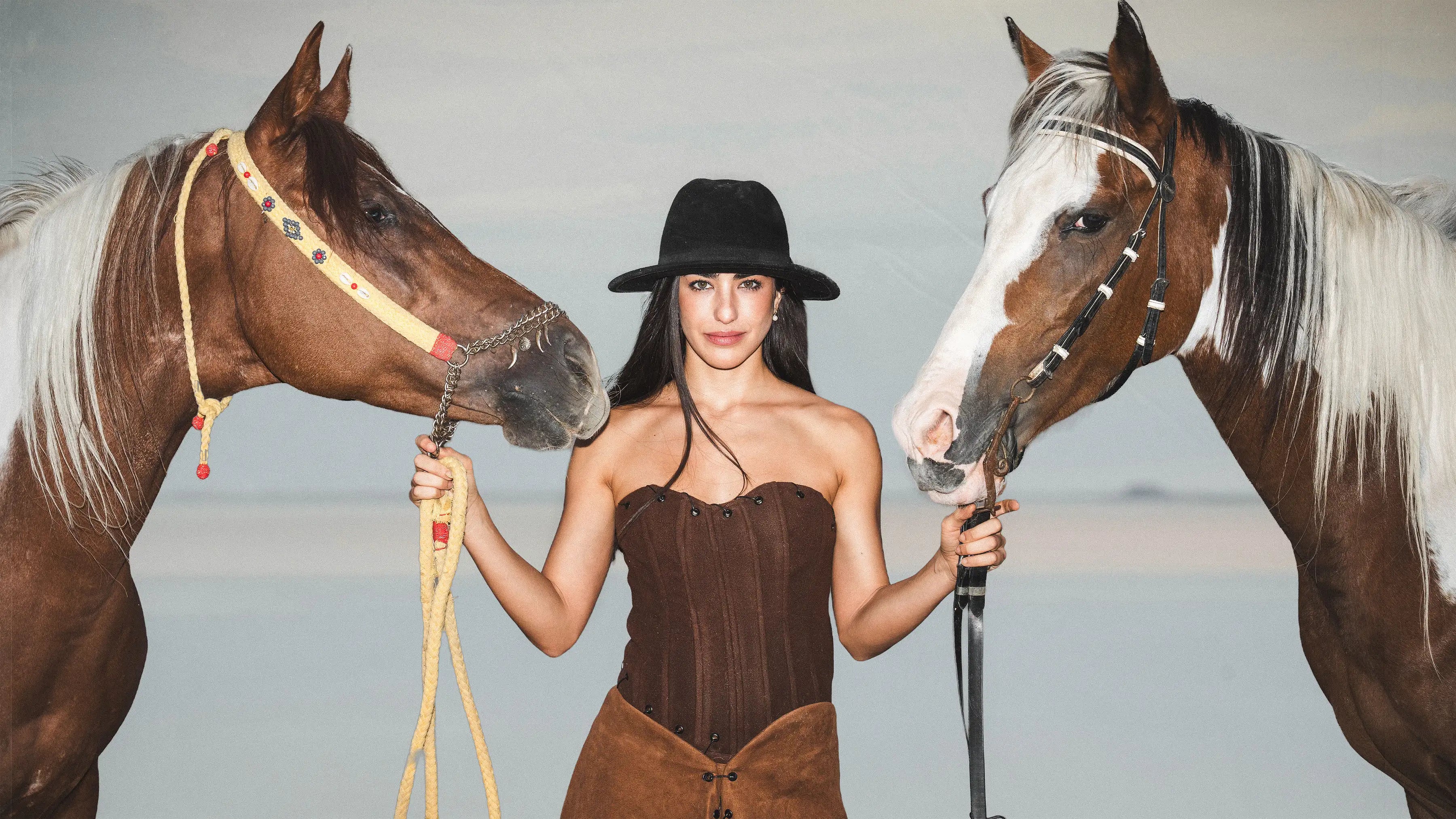 Baloska brown corset top and black western hat cowgirl fashion shoot with horses